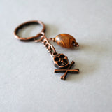 Copper Color Skull And Crossbones With Agate Accent Keychain